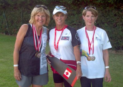 Three River Spirit paddlers wearing medals