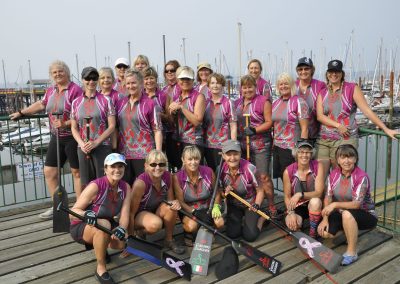 River Spirit paddlers in team jerseys on the dock at the 2017 Comox regatta