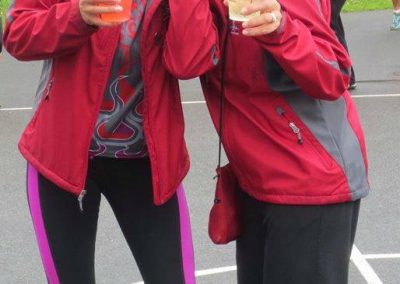 Two River Spirit paddlers in red team jackets