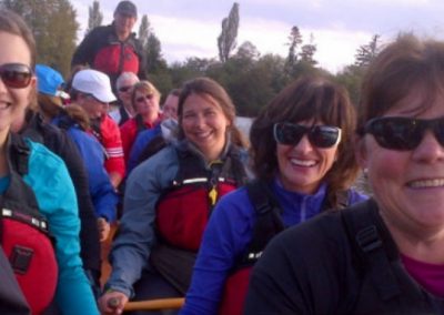 River Spirit paddlers smiling together in sunglasses